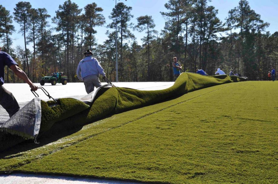 Workers put down turf in Bear Branch Park in The Woodlands. Some critics nationwide are voicing health concerns about the material's crumb rubber filler. Photo: Courtesy / The Woodlands Township